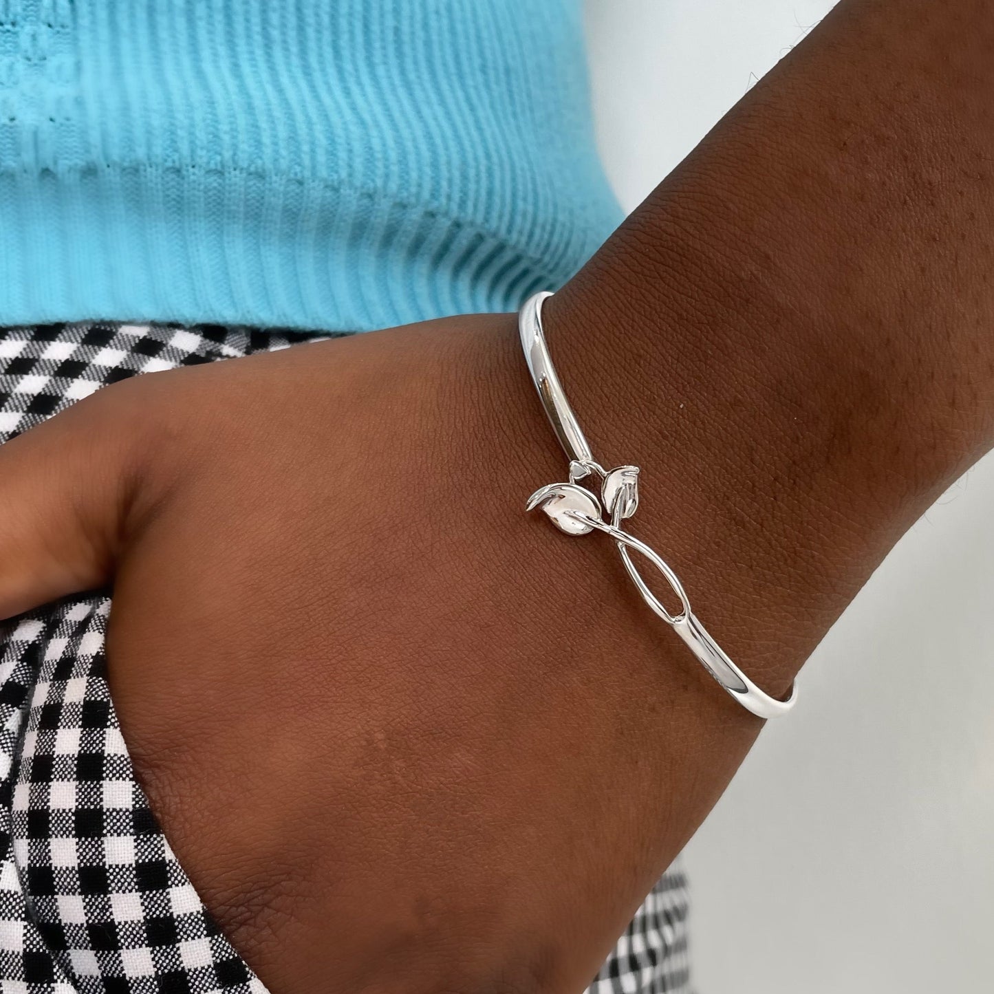 leaf hook silver bangle shown on wrist