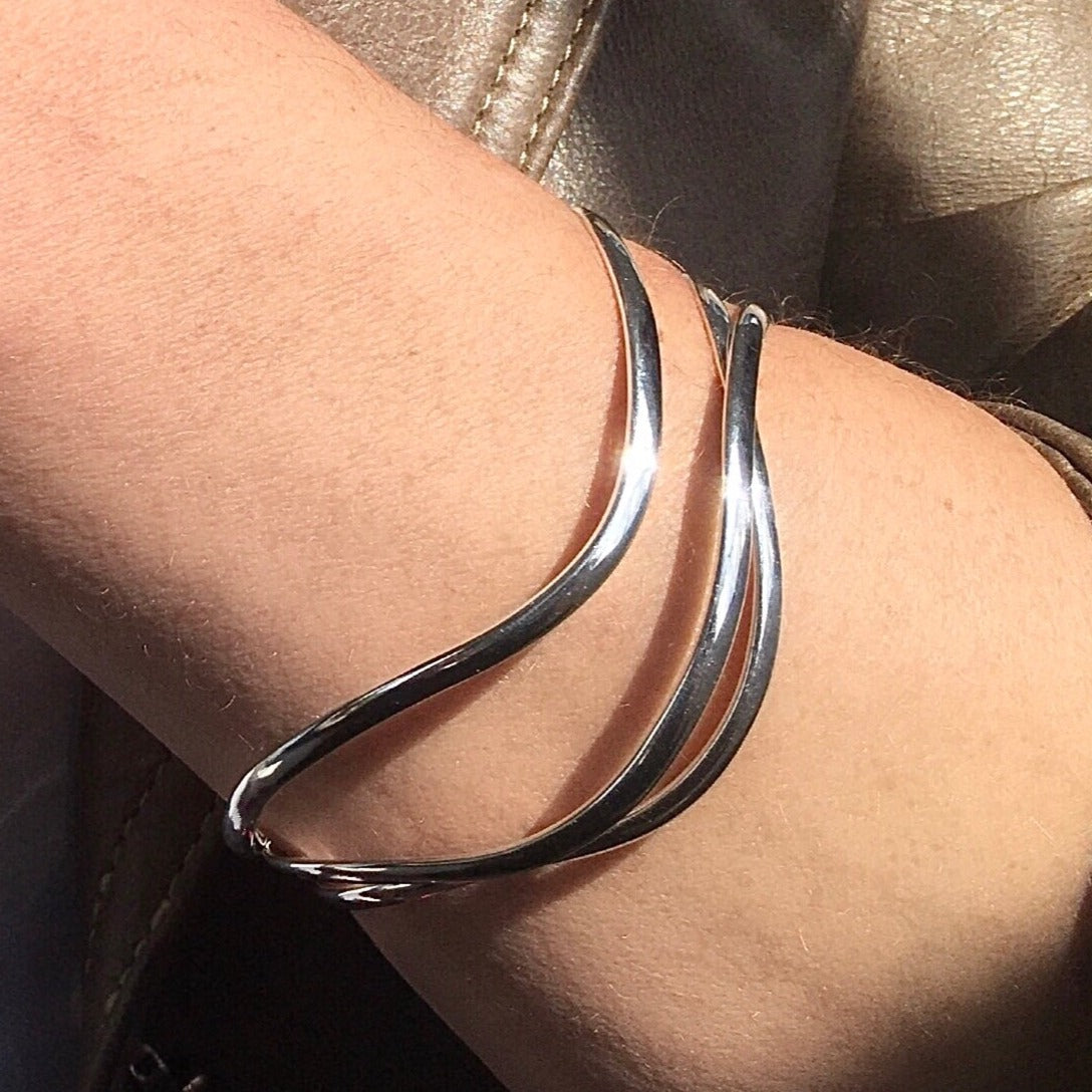 3 swirls sterling silver trinity bangle being worn by model